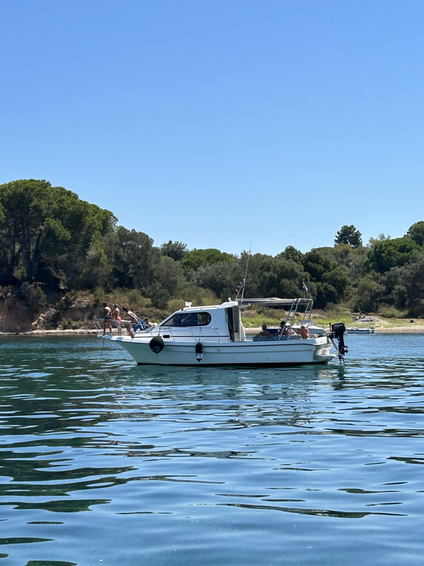 Friends enjoying a private boat cruise in Corfu